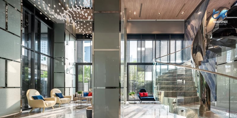 Grand lobby with modern seating and a dramatic spiral staircase.