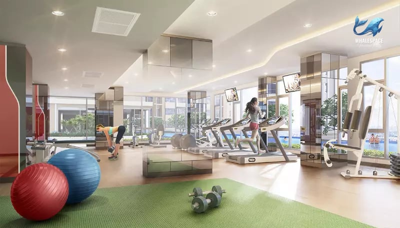 Bright and spacious fitness center featuring modern cardio machines, weight training equipment, and large windows with a refreshing pool view.