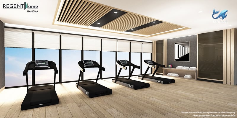 State-of-the-art fitness center equipped with multiple treadmills, offering panoramic city views through large windows.