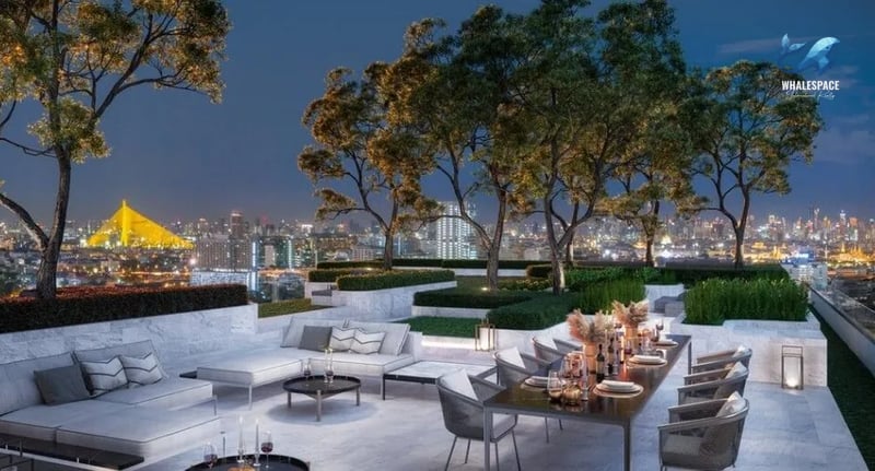 Rooftop lounge with dining area and panoramic city views at dusk