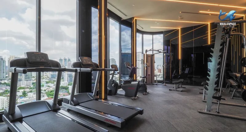 Well-equipped fitness center with cardio machines and city views.