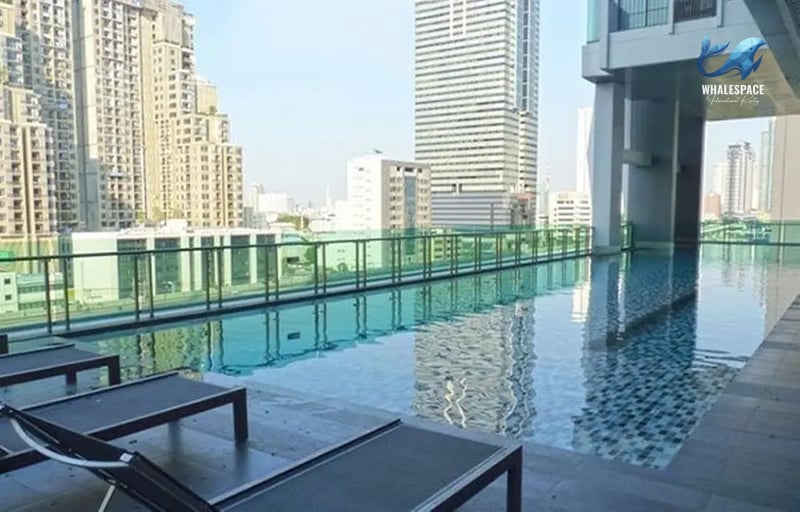 Rooftop swimming pool with city skyline views and sun loungers