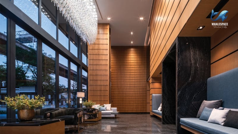 Grand lobby featuring a dramatic crystal chandelier, floor-to-ceiling windows, and luxurious seating arrangements.
