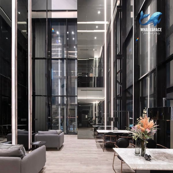 Luxurious lobby with polished floors, mirrored walls, and contemporary seating.