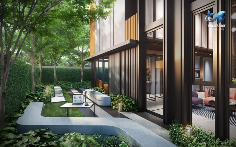 Lush garden area with integrated modern outdoor seating, providing a tranquil green space next to the building.