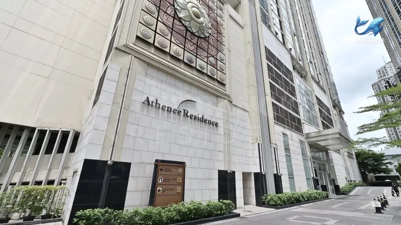 Grand exterior facade of a modern residential building featuring classic architectural details and elegant signage