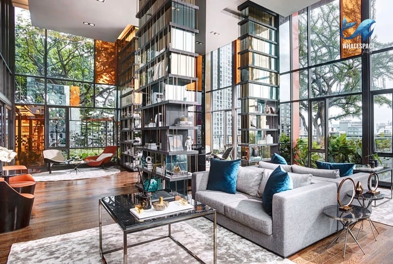 Grand lobby with high ceilings, large windows, and modern seating arrangements