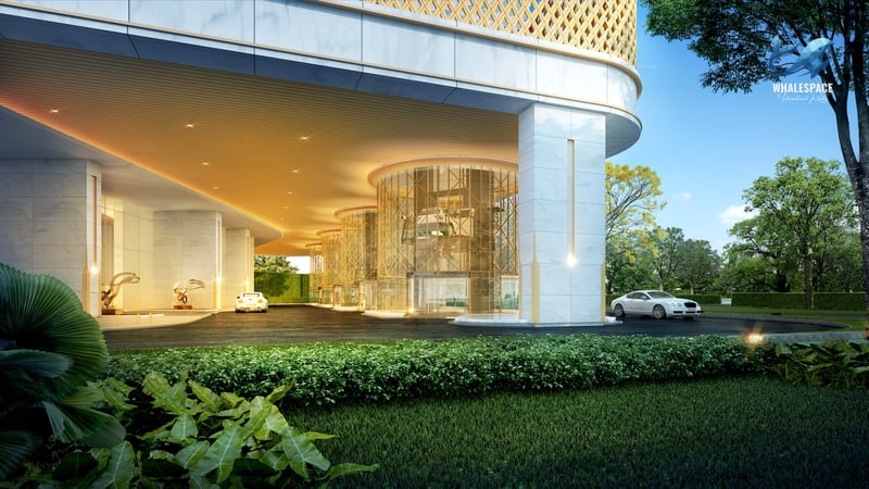 Luxurious building entrance with a spacious circular driveway, marble facade, and manicured landscaping