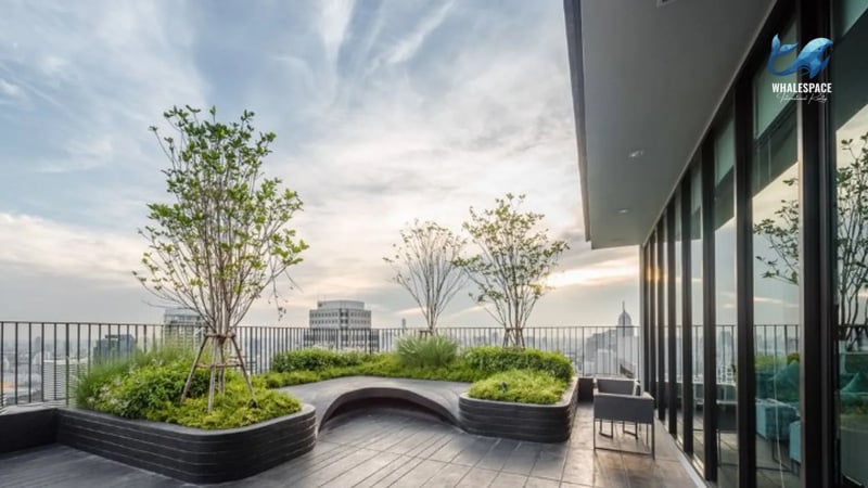 Serene rooftop garden with carefully cultivated trees, landscaped greenery, and seating areas, providing a tranquil escape with urban skyline views.
