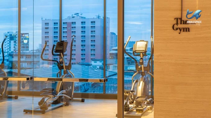 Well-equipped fitness center with cardio machines and city views.