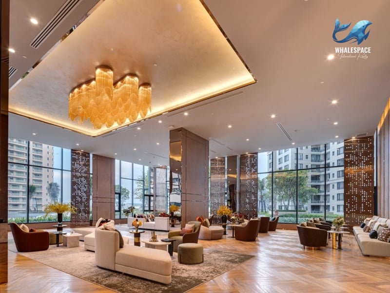 Spacious grand lobby with high ceilings, luxurious chandeliers, and comfortable seating arrangements.