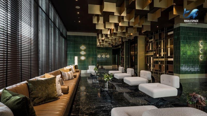 Luxurious lobby with marble floors, plush seating, and striking gold and green accents