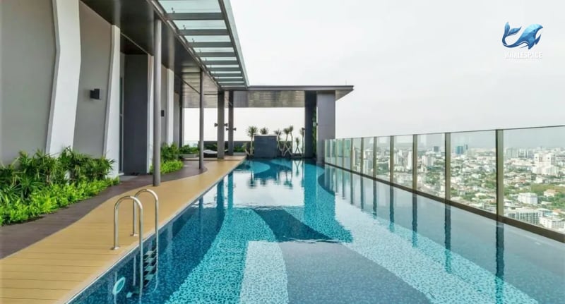 Infinity swimming pool on a high floor overlooking the city skyline