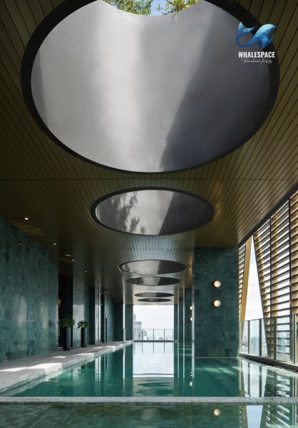 Indoor swimming pool with a stunning city view, featuring a modern design and ambient lighting
