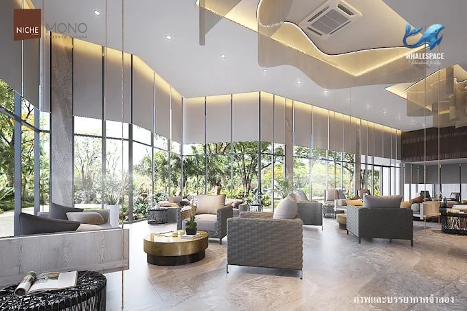 Elegant lobby with comfortable seating, modern lighting, and large windows overlooking lush greenery