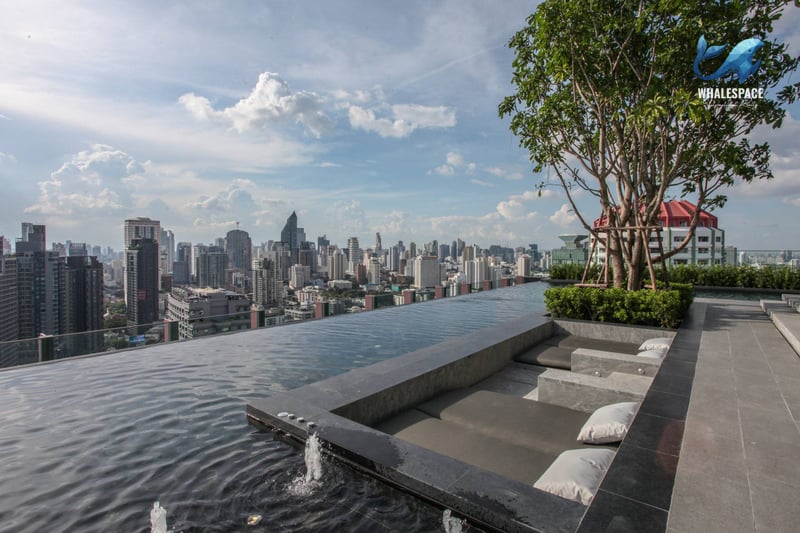 Rooftop infinity pool overlooking a sprawling cityscape