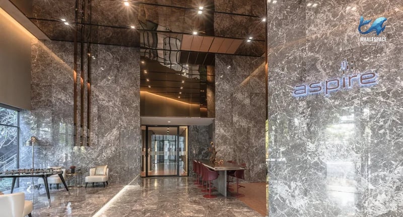 Luxurious marble-clad lobby with contemporary seating and ambient lighting.