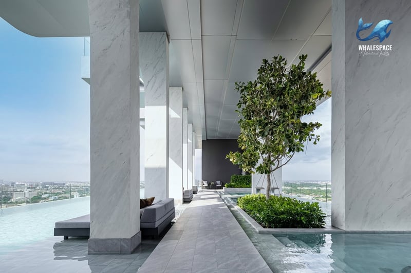 Expansive rooftop area featuring a serene infinity pool, lush greenery, and panoramic city views.