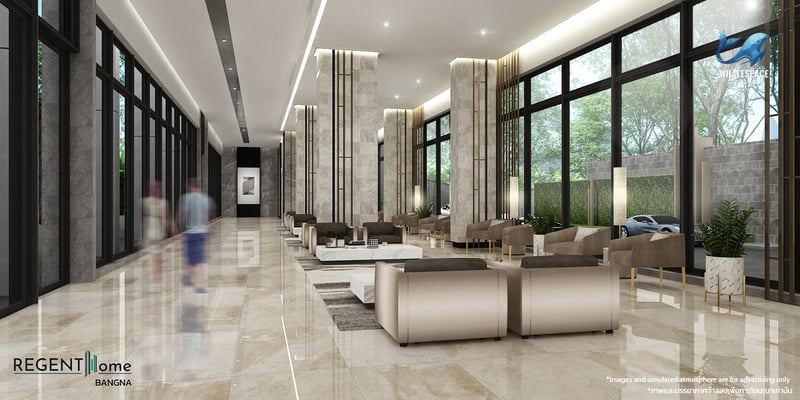 Grand lobby featuring polished marble floors, contemporary seating arrangements, and elegant column accents, bathed in natural light from floor-to-ceiling windows.