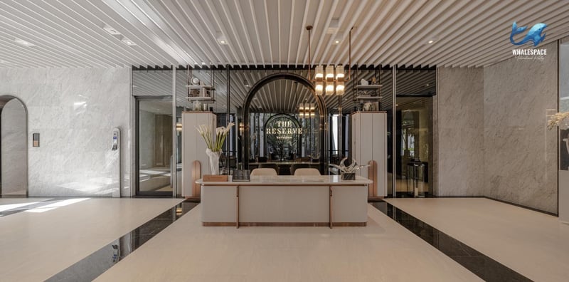Elegant reception desk with marble accents and contemporary lighting, creating a welcoming ambiance.