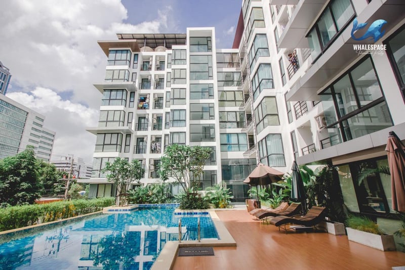 Inviting swimming pool area with wooden deck and lounge chairs