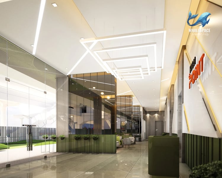 Sleek and modern lobby entrance with high ceilings, striking geometric lighting, glass walls, and a glimpse of a lounge area.