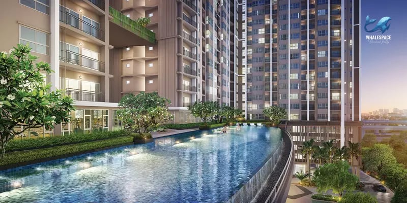 An inviting infinity-edge swimming pool integrated into the modern building, offering views of the city skyline and lush surrounding greenery.