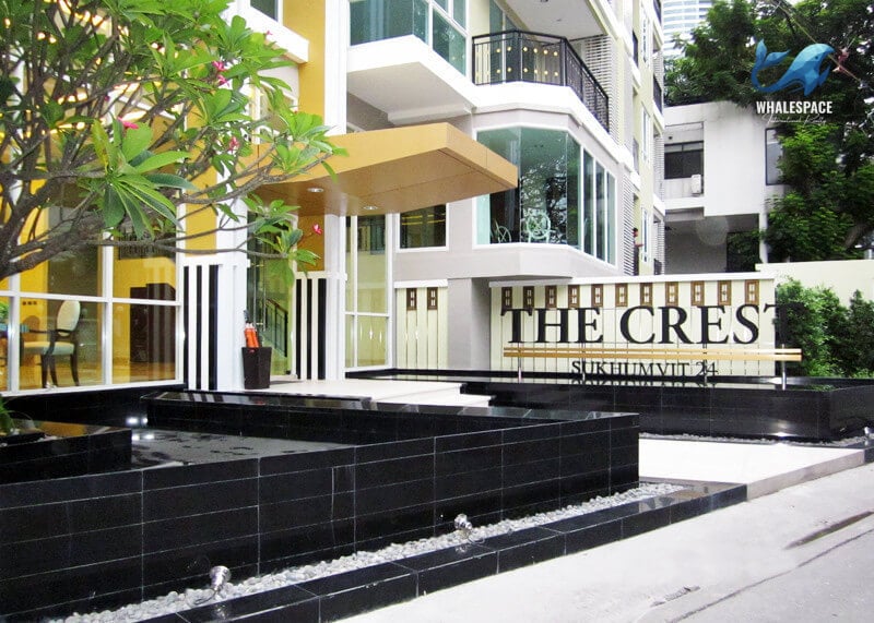 Grand building entrance with decorative water features and modern architectural elements.