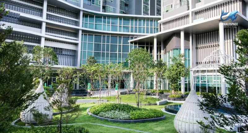 Serene landscaped garden with manicured lawns, unique seating pods, and elegant architectural elements.