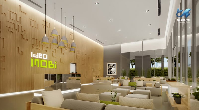 Grand lobby with high ceilings, warm wooden feature wall, and contemporary pendant lighting, featuring comfortable seating arrangements.