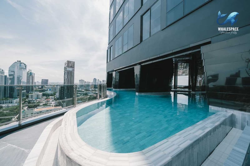 Serene rooftop infinity pool overlooking the cityscape.