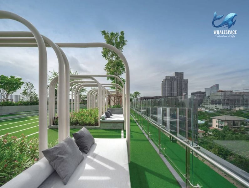Serene rooftop lounge area with comfortable seating and panoramic city views.