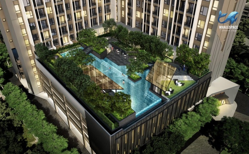 Expansive rooftop swimming pool area surrounded by lush greenery and modern residential buildings.