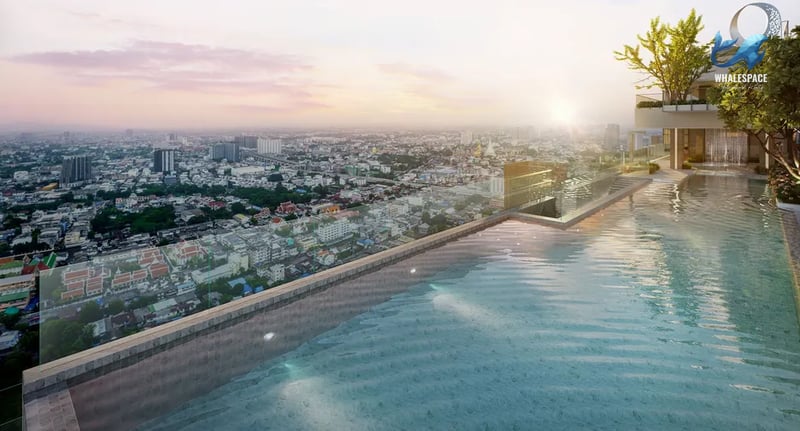 Infinity pool overlooking a sprawling cityscape at sunset, with lush trees and modern architecture.