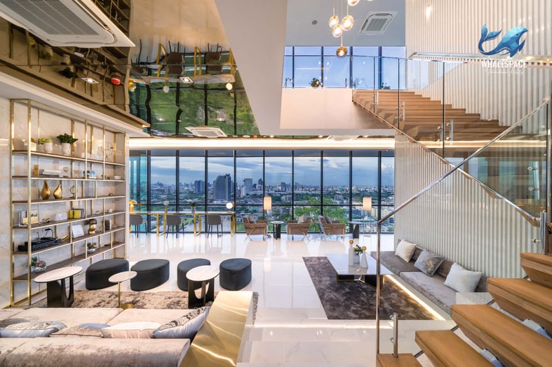 Grand modern lobby with marble floors, high ceilings, and city views
