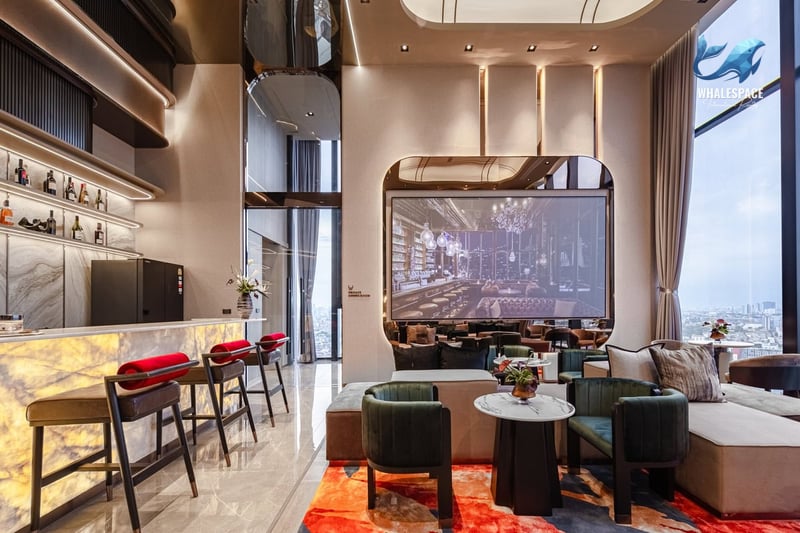 Luxurious resident lounge with a stylish bar, comfortable seating, and ambient lighting, perfect for socializing.