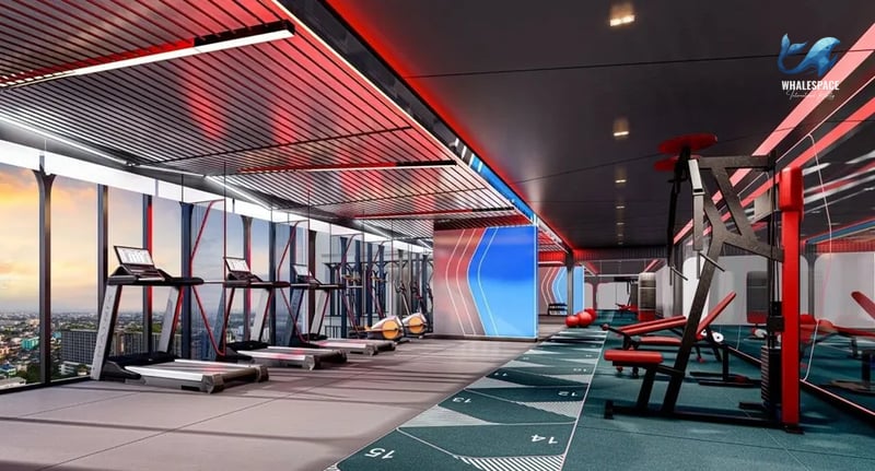 State-of-the-art fitness center equipped with treadmills, weight machines, and vibrant red accents.