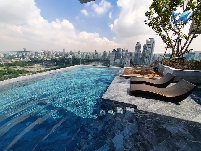 Stunning infinity pool on a rooftop offering panoramic city views during the day.