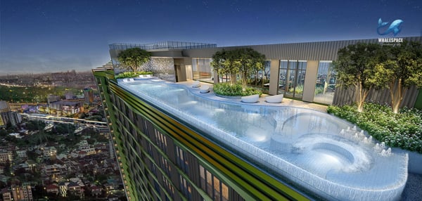 Stunning rooftop infinity pool with integrated seating, surrounded by greenery, offering expansive night-time city views.
