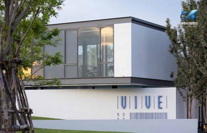 Contemporary building exterior with large glass windows and minimalist signage.