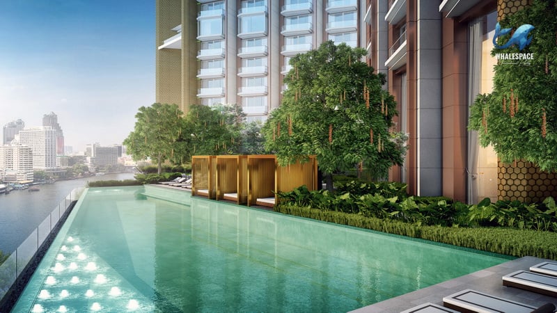 Infinity-edge swimming pool overlooking the river and cityscape, with private cabanas and lush greenery