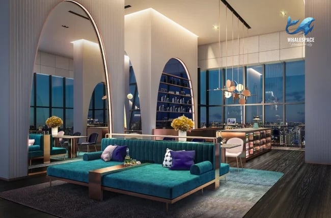 Elegant lounge space with deep teal sofas, decorative lighting, and cityscape backdrop.