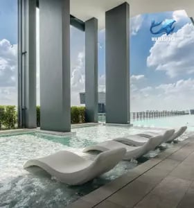 Serene infinity pool with modern lounge chairs and city backdrop