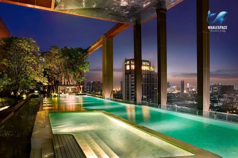 Rooftop infinity pool with city skyline views at dusk