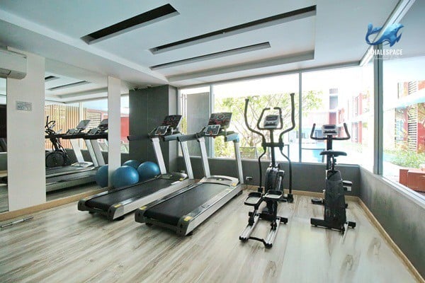 Well-equipped fitness center featuring treadmills, elliptical machines, and stationary bikes.