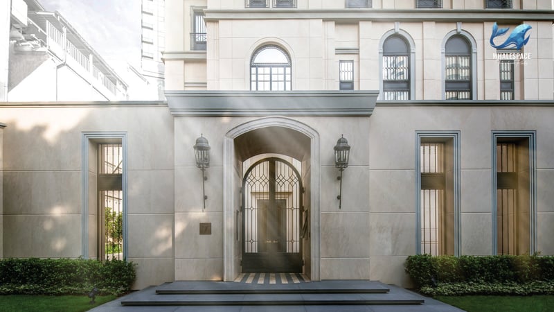 Elegant arched entryway with a wrought-iron gate and decorative wall sconces