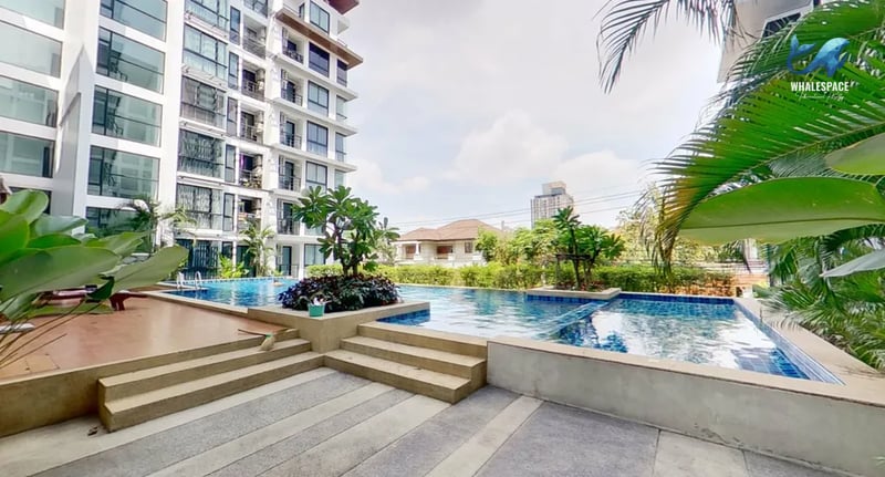 Resort-style swimming pool with tiered levels and lush tropical landscaping