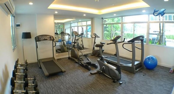 Well-equipped fitness center with treadmills, stationary bikes, and free weights.