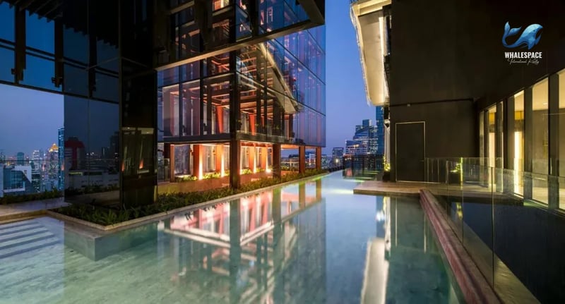 Reflective infinity pool at dusk with stunning city skyline views