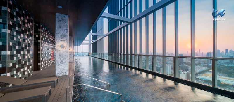 Indoor lap pool with stunning city views during sunset